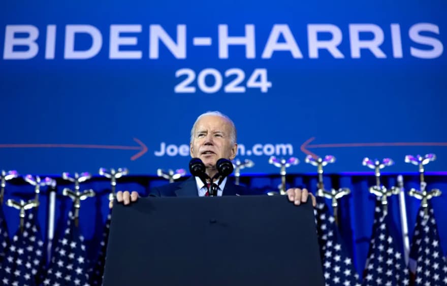 Joe Biden prepares to deliver a speech from a podium.