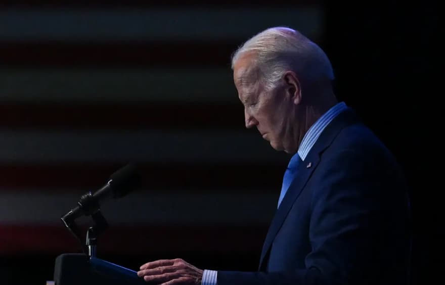 Joe Biden prepares to deliver a speech from a podium.